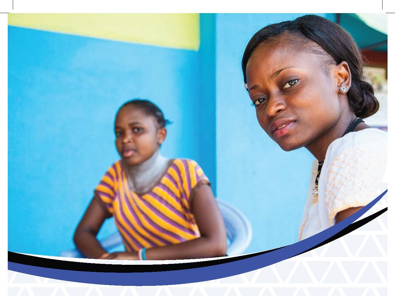 two young women look to camera, sat together, blue background