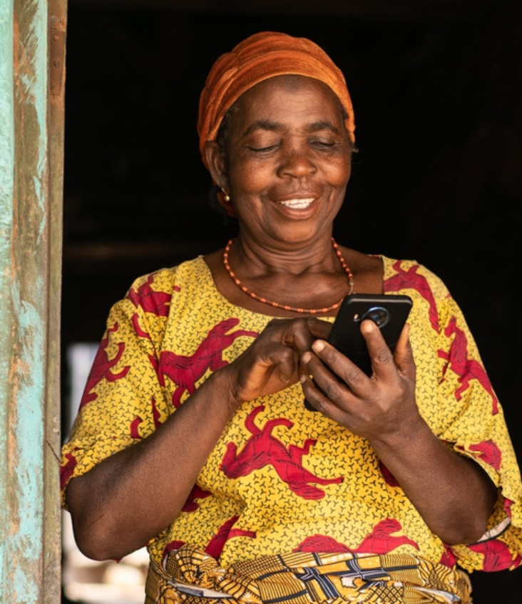 Smiling elderly woman looking at her phone.