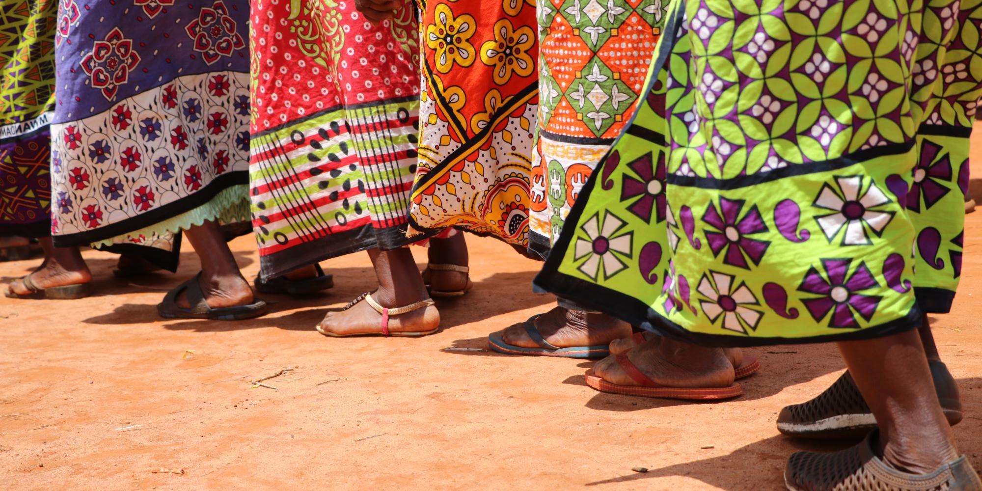 Image of Kenyan women's feet and colourful dresses