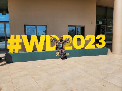 Lusungu Kalanga in front of the Women Deliver conference sign in Kigali. 